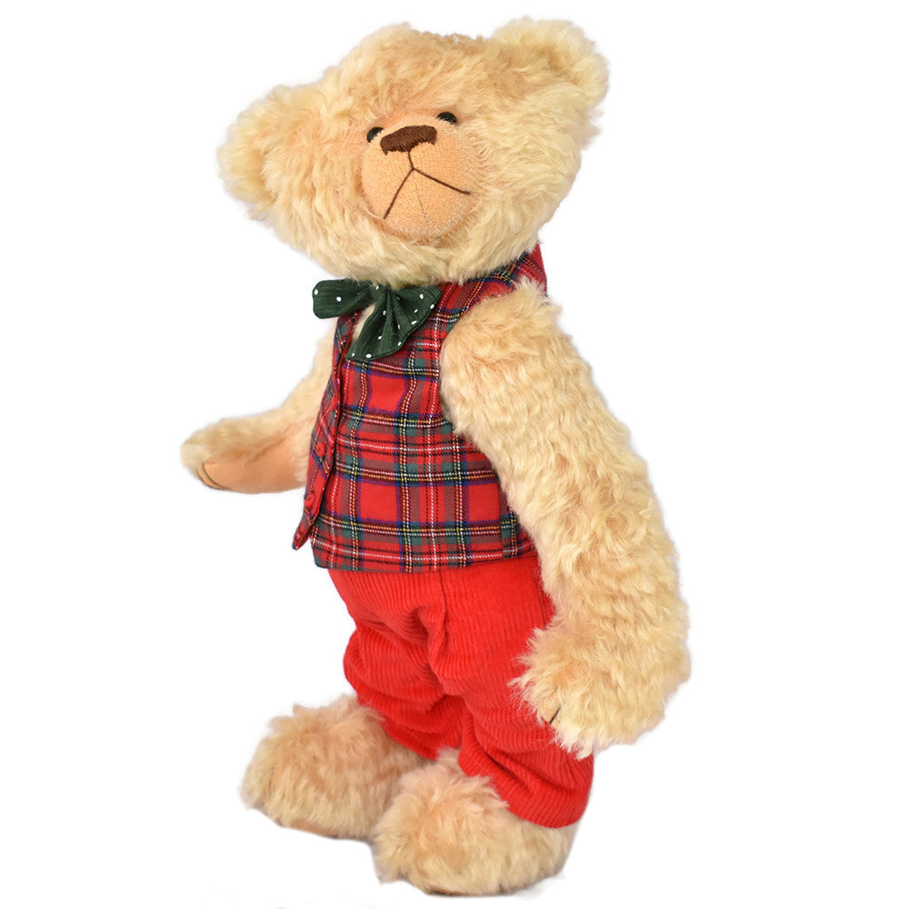 Collectable teddy bear wearing a plaid shirt and red pants.