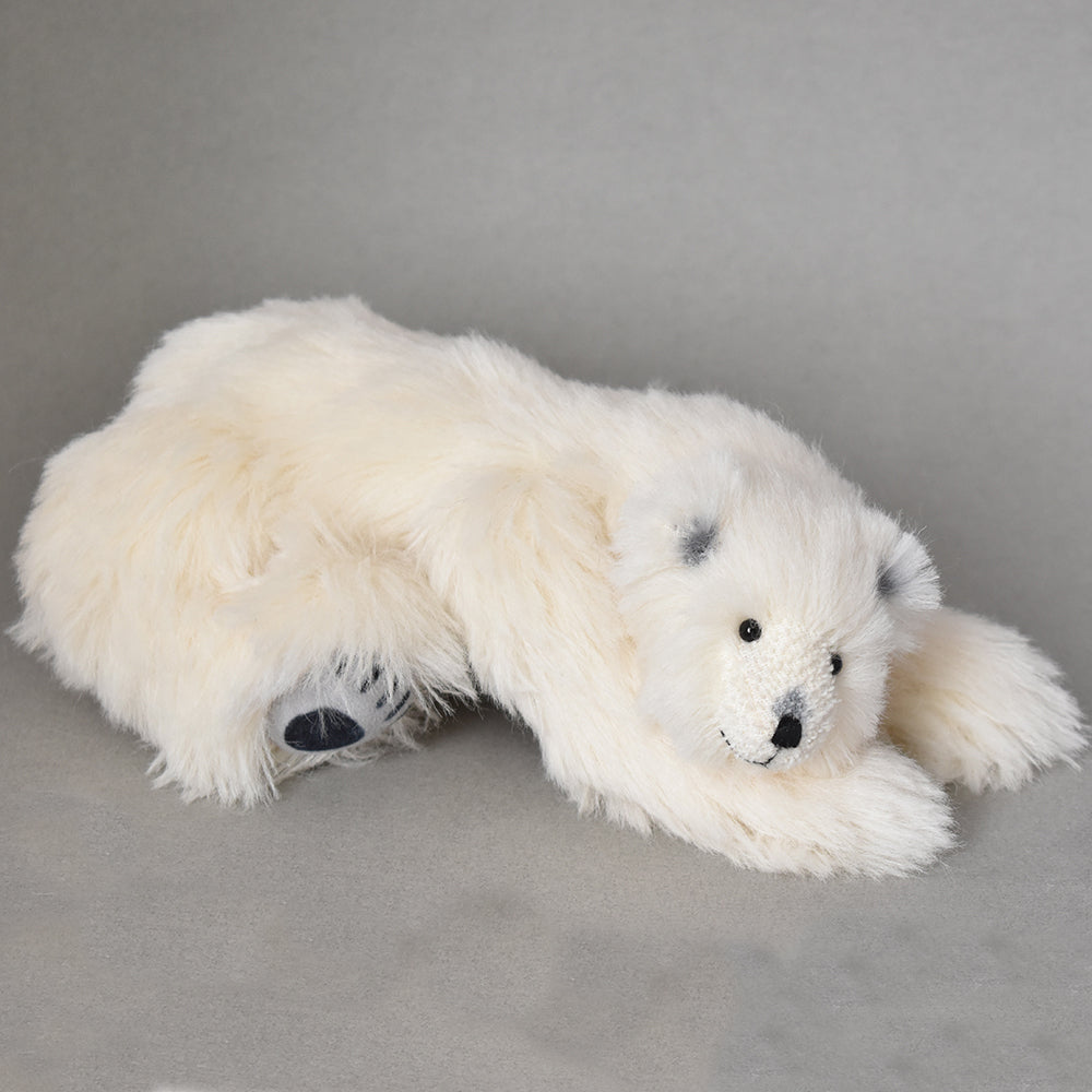 Sweet polar bear reclining on front feet