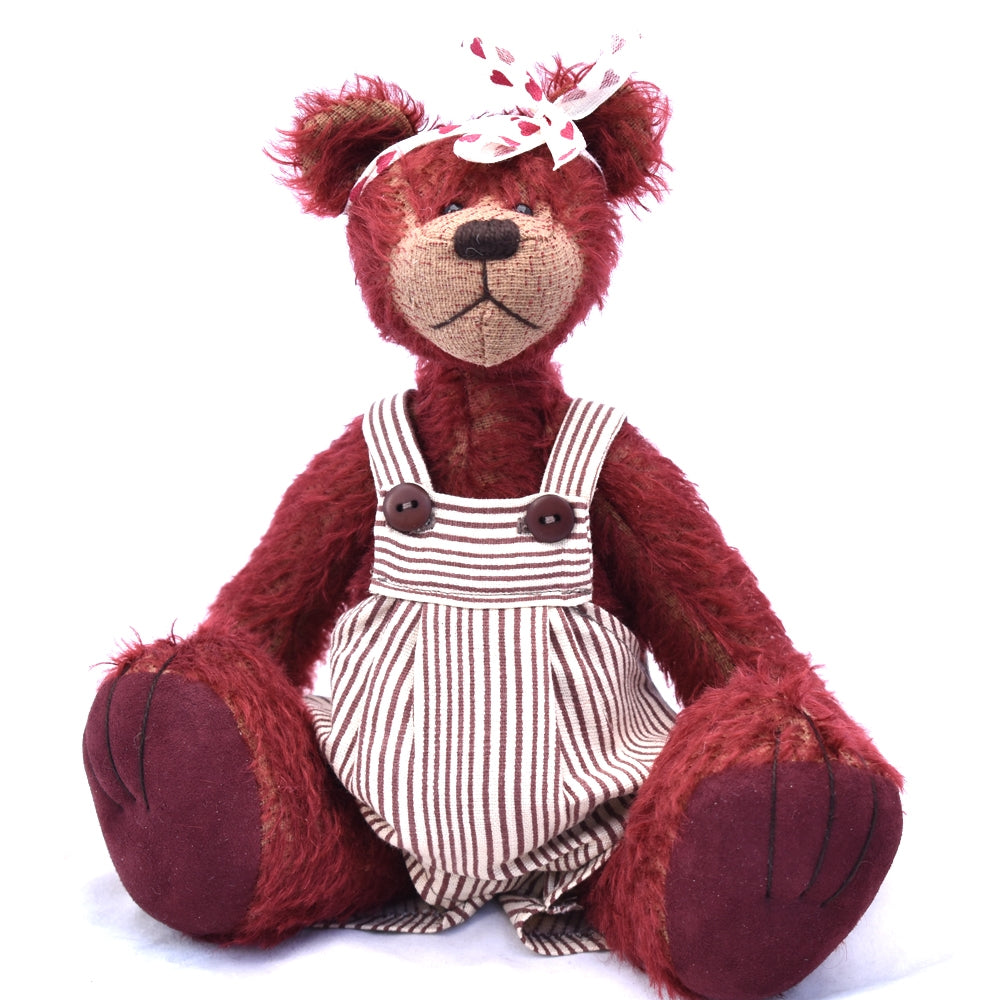 Maroon teddy bear sitting