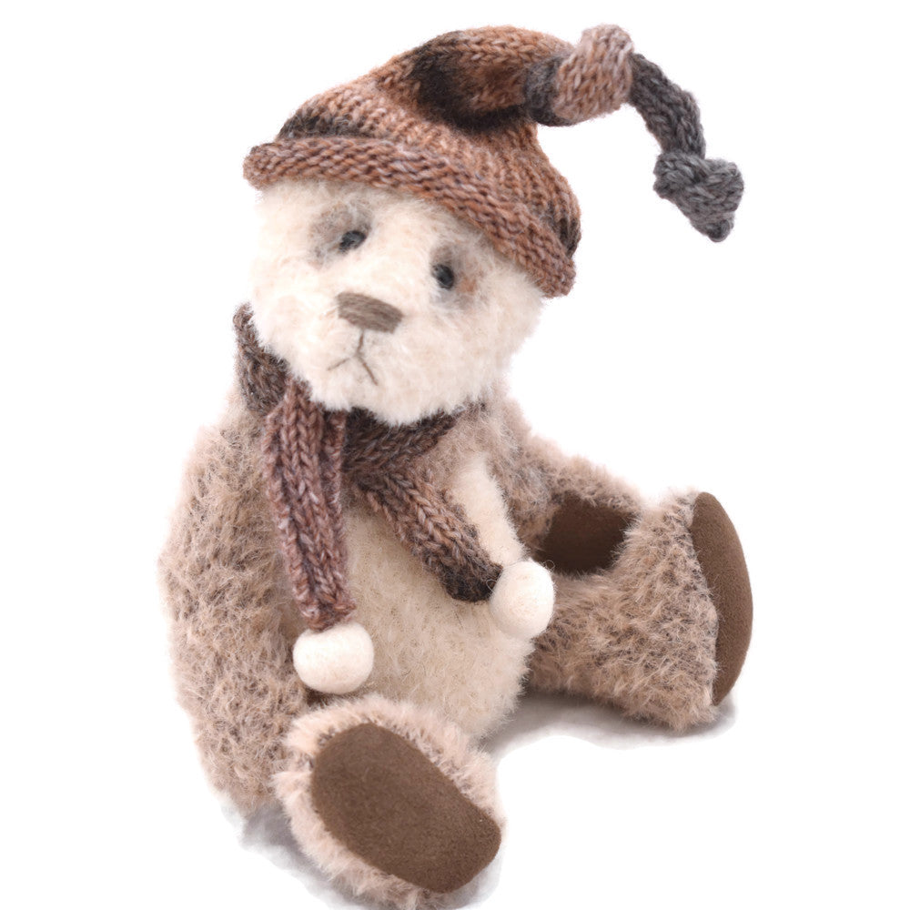 Ivory and brown panda bear seated