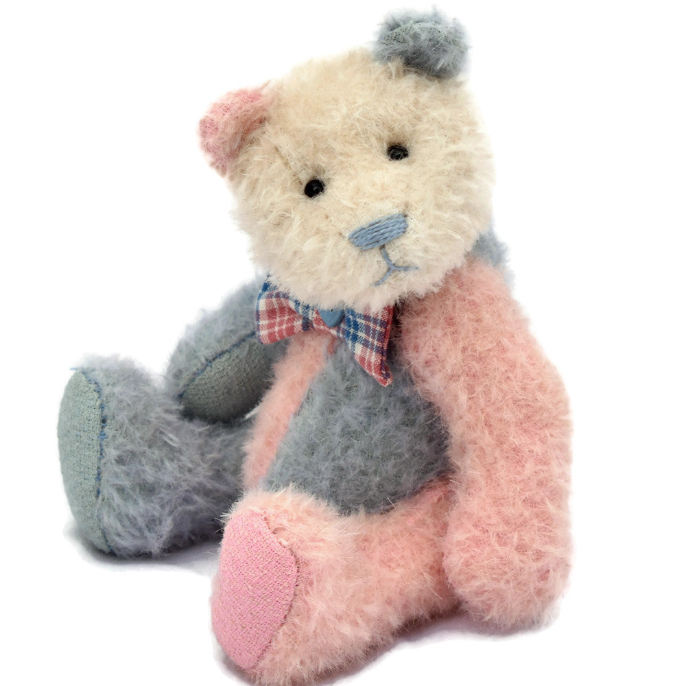 Blue and pink panda teddy bear sitting